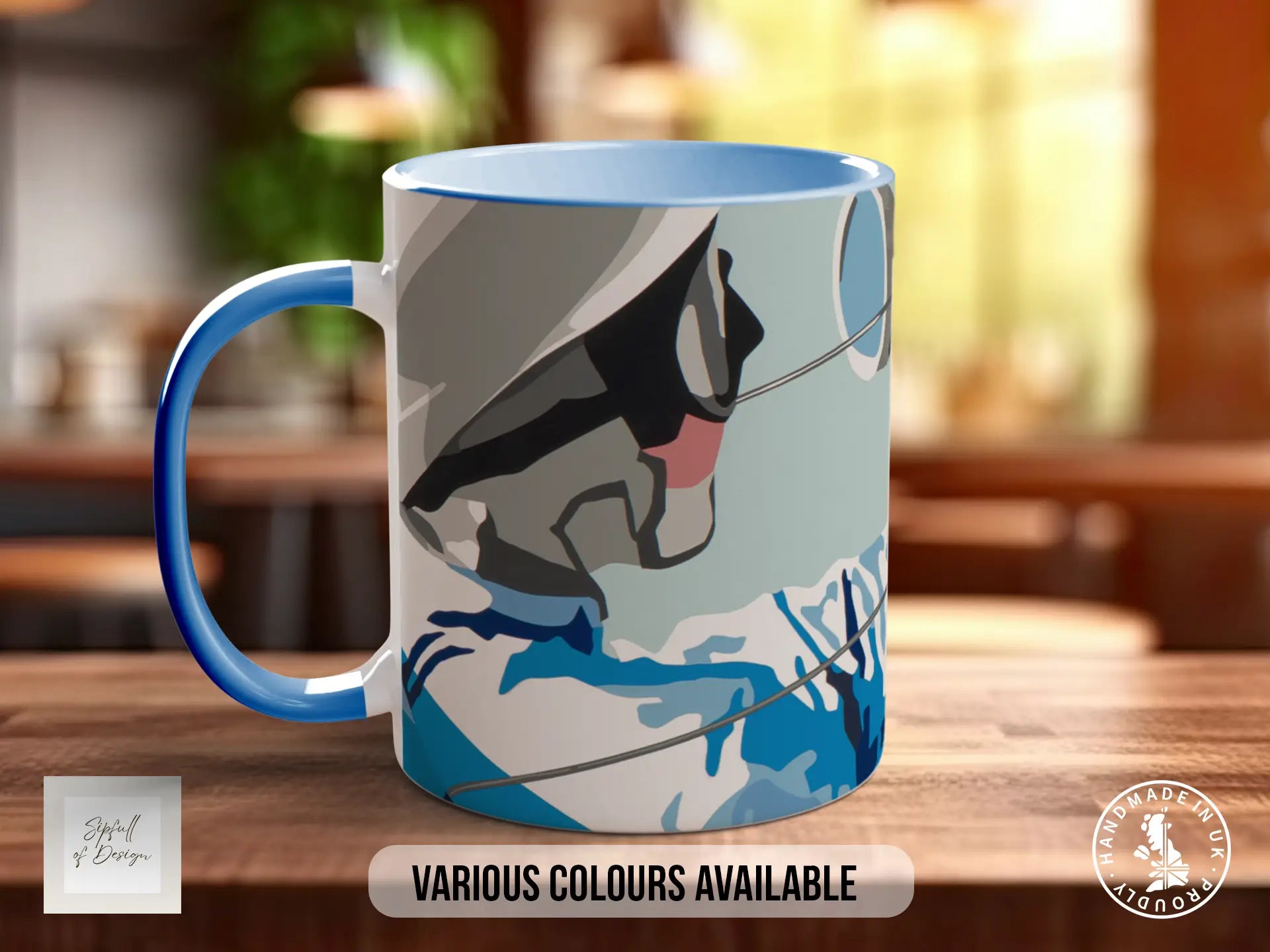 A blue and white mug with a graphic design on it, sitting on a wooden surface.
