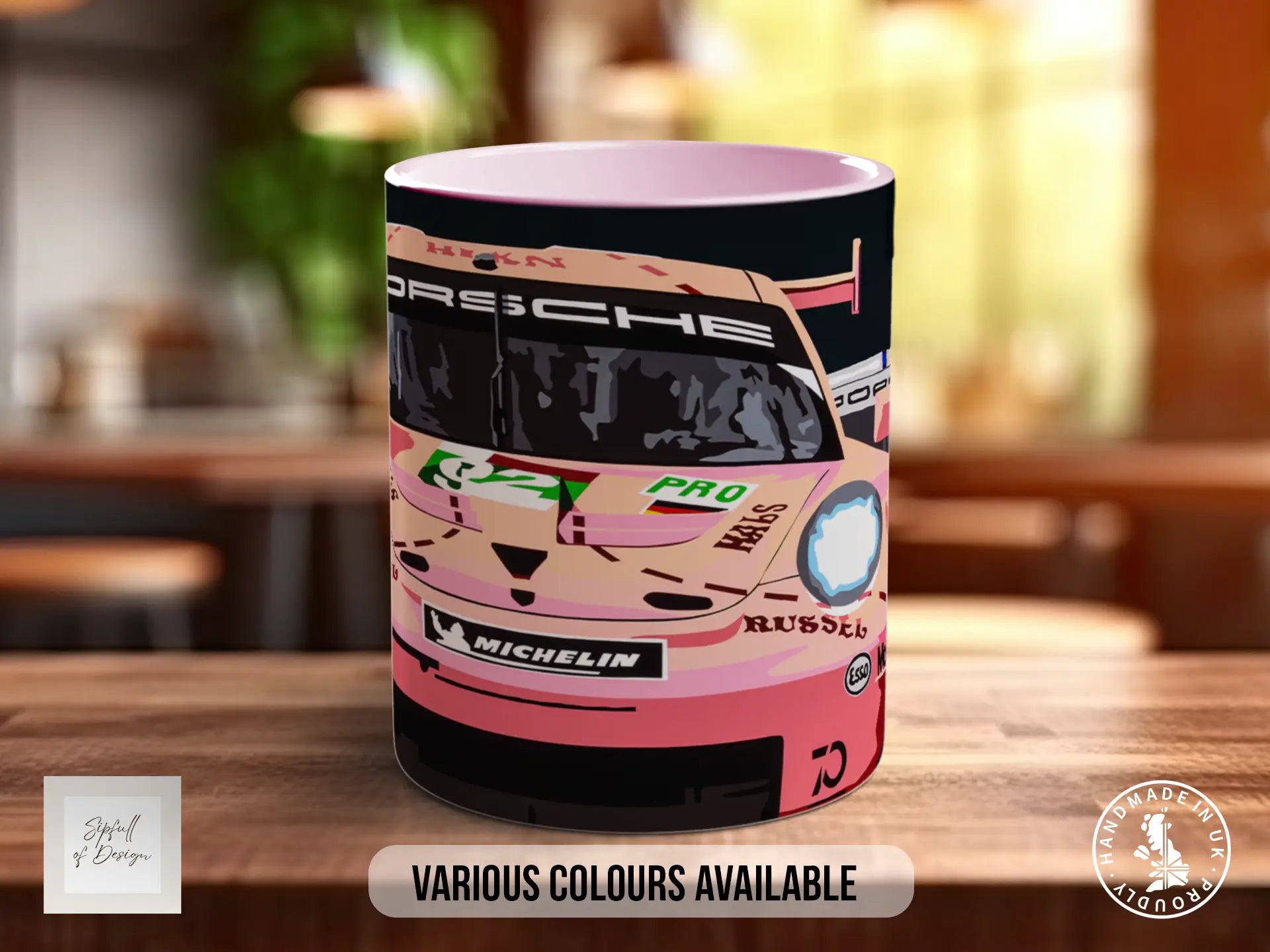 A pink and black mug featuring an illustration of a racing car, with various sponsor logos and text.
