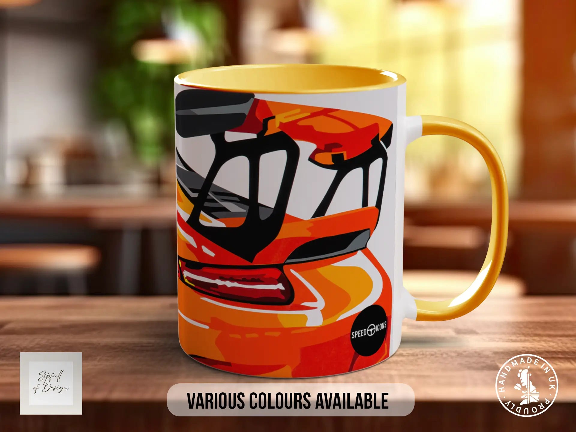 A colorful mug with an abstract design featuring a car or vehicle, placed on a wooden surface.