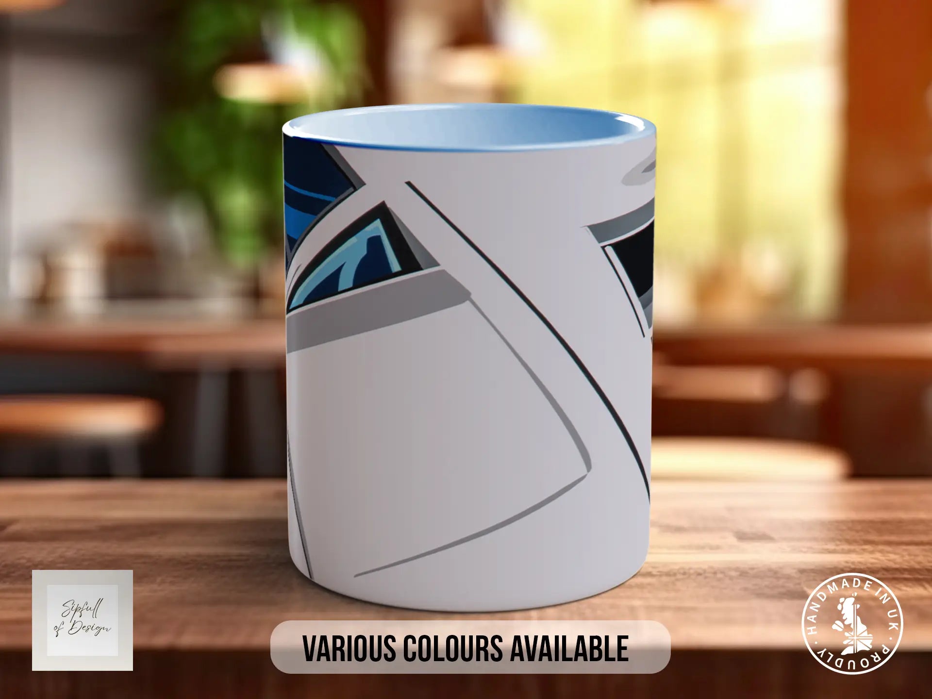 A white mug with a blue and gray abstract design on it, sitting on a wooden surface.