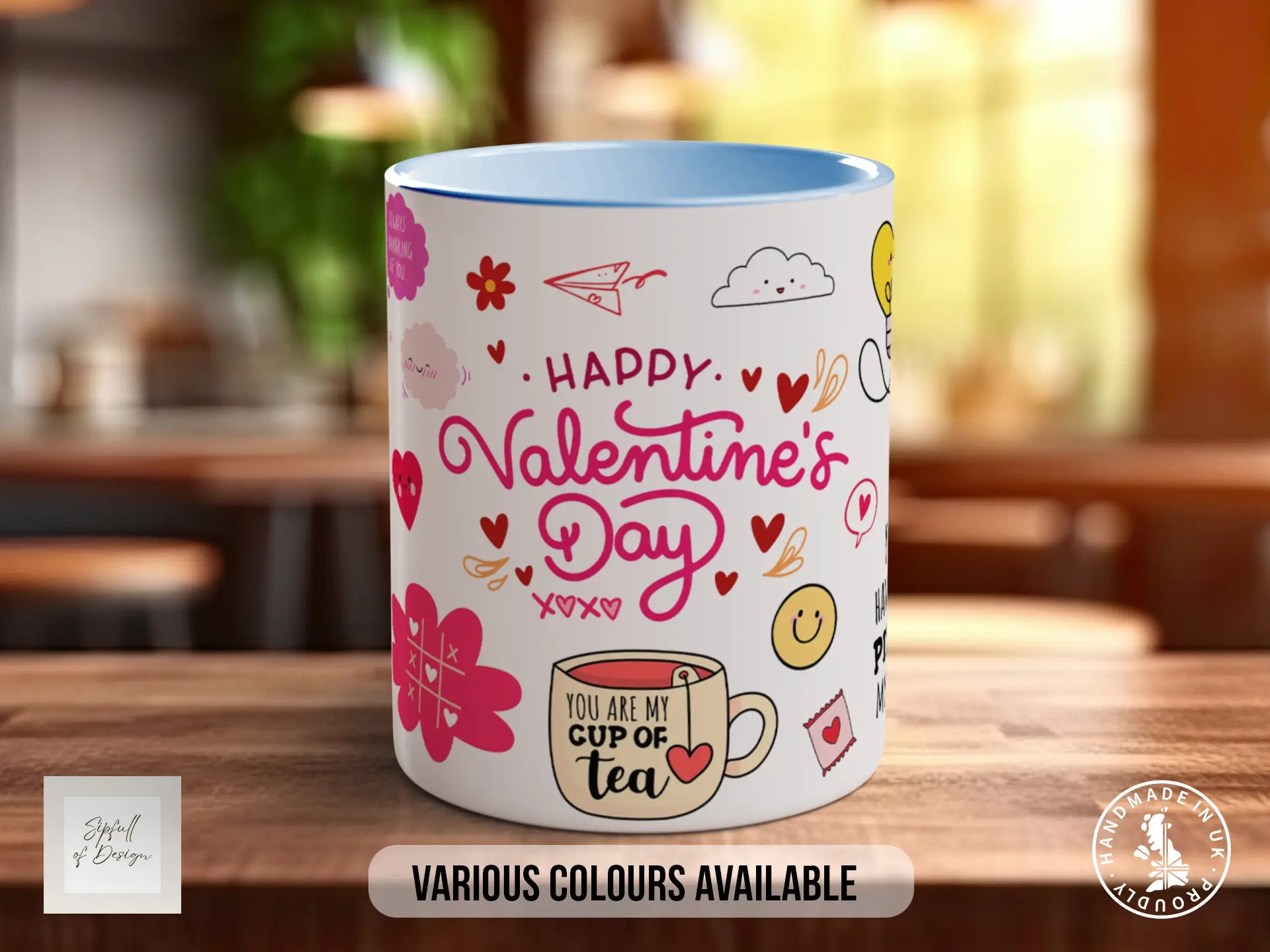 A white mug with a colorful design featuring various Valentine's Day-themed elements such as hearts, flowers, and a cup of tea.