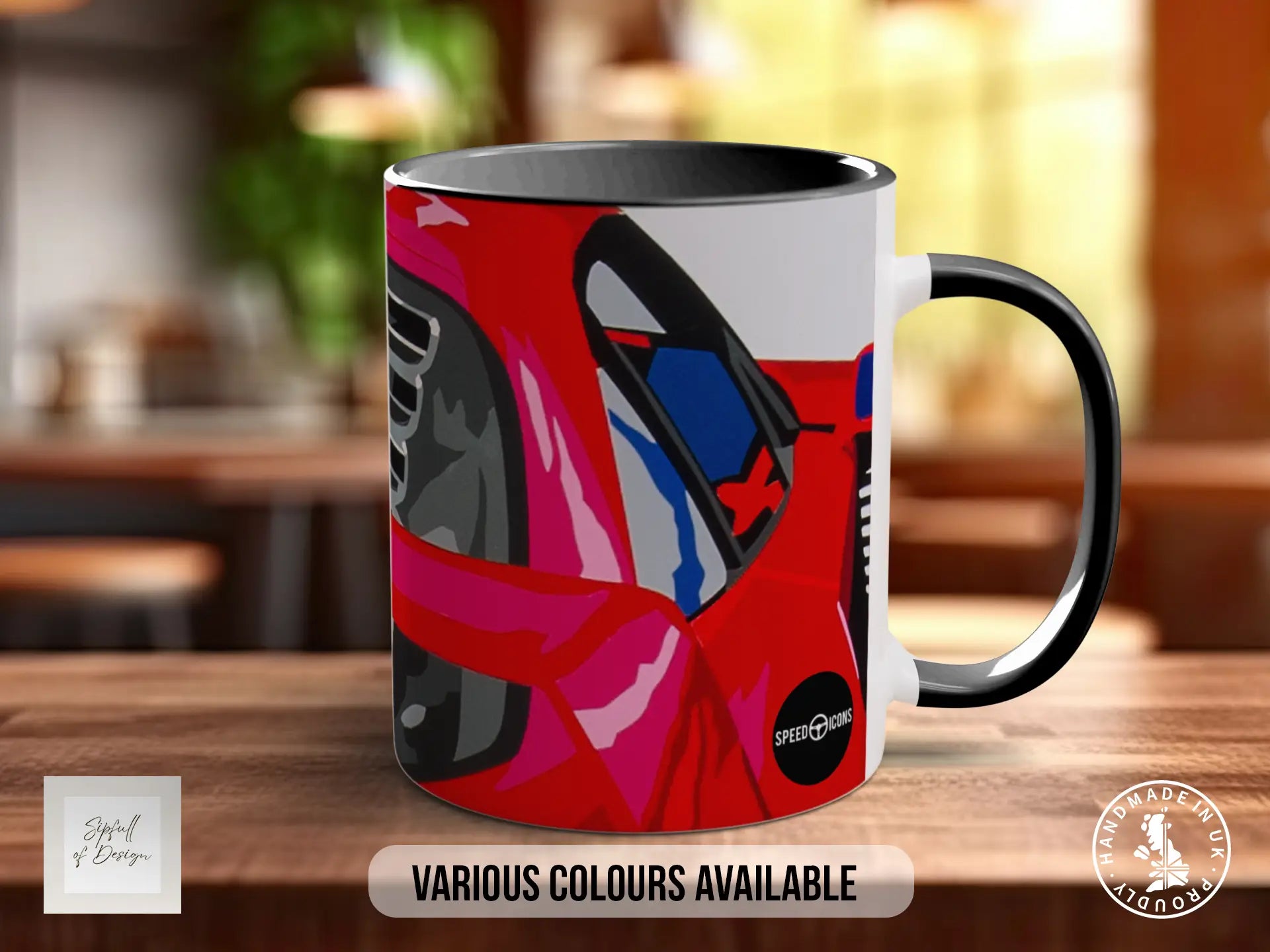 A black and white mug with a colorful graphic design featuring a car or vehicle. The mug is placed on a wooden surface, and there is text indicating that various colors are available.