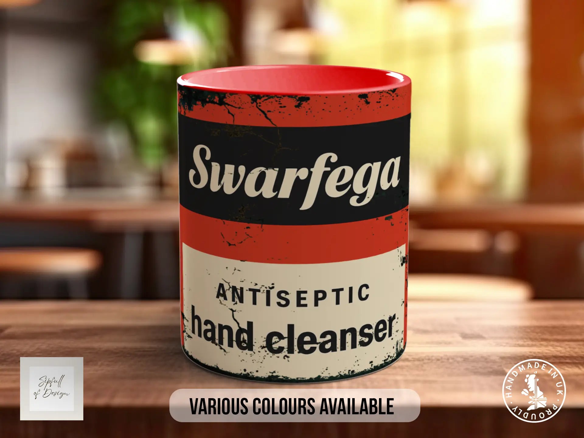 A red and white mug with the text "Swarfega Antiseptic hand cleaner" printed on it, sitting on a wooden surface.
