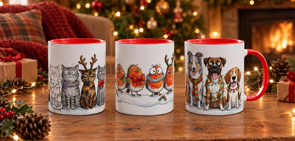 Christmas Cats, Christmas Robins and Christmas Dogs mugs on a table by the Christmas tree