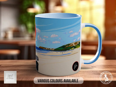 A mug with a beach scene printed on it, sitting on a wooden surface.