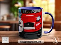 A red and blue ceramic mug with a graphic of a car on it, placed on a wooden surface.