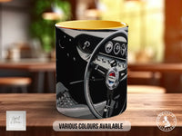 A coffee mug with a design featuring a steering wheel and dashboard of a car, along with various car-related icons and symbols.