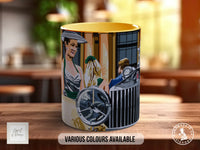 A ceramic mug with an illustration of a woman and a car on it, placed on a wooden surface.