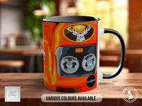 A colorful mug with an orange and black design featuring a deer head and a car engine.