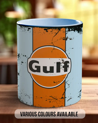 A ceramic mug with a distressed, orange and white design featuring the word 