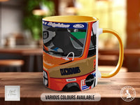 A colorful mug with an illustration of a racing car on it, placed on a wooden surface.