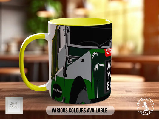 A yellow and green mug with a graphic design of a vehicle, likely a car, on it.