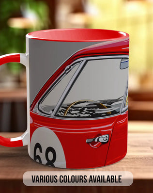 A red and white mug with a graphic of a car on it, placed on a wooden surface.