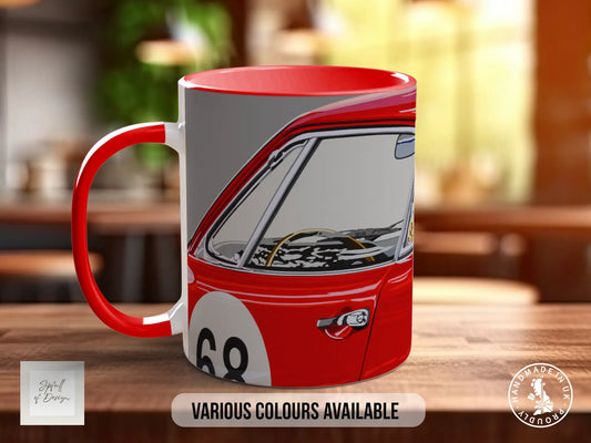 A red and white mug with a graphic of a car on it, placed on a wooden surface.