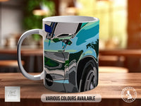 A white ceramic mug with a colorful abstract design featuring a car and other vehicles. The mug is placed on a wooden surface, and there is text indicating that various colors are available.