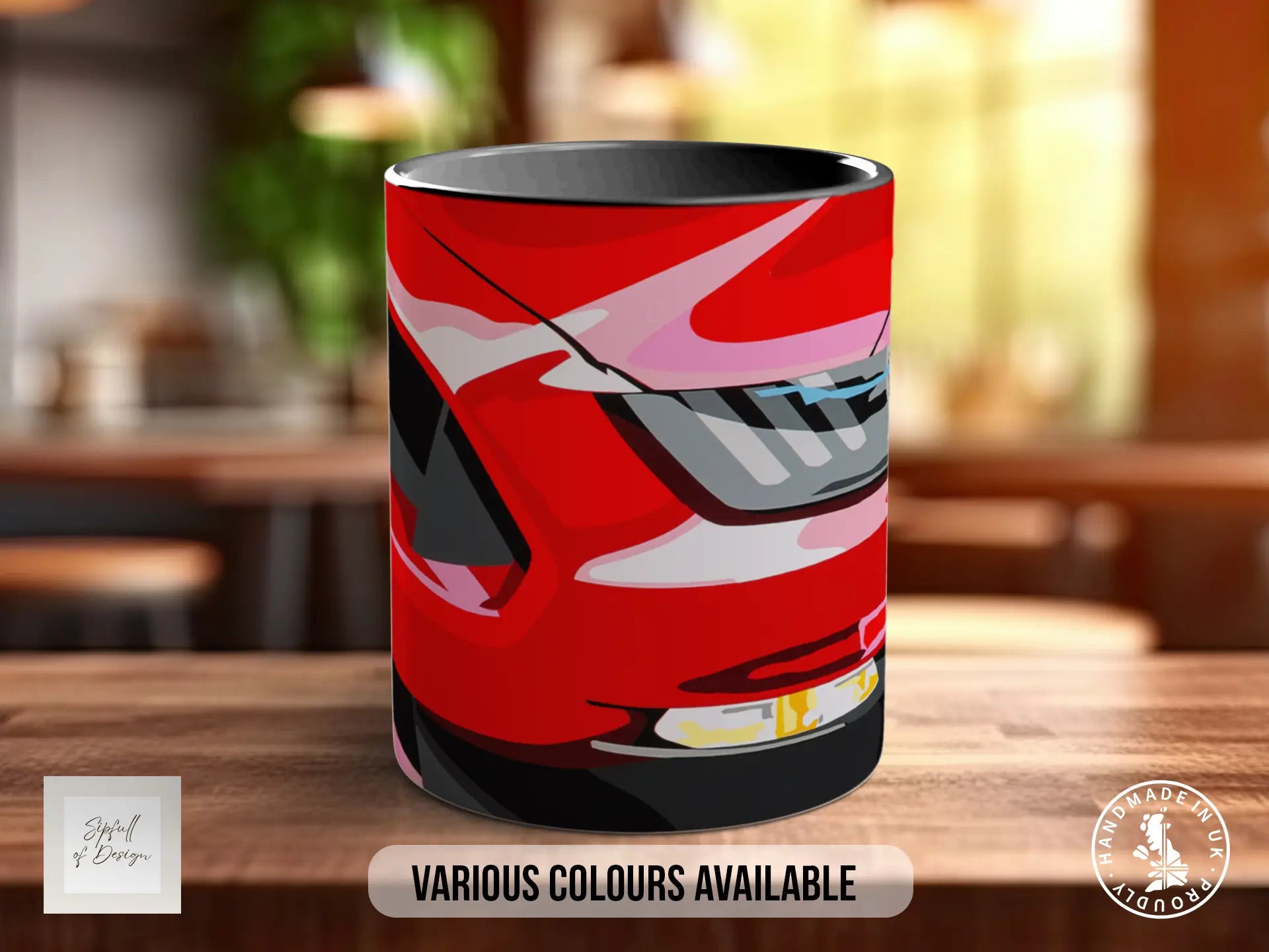 A red and black mug with a graphic design of a car on it, placed on a wooden surface.