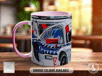 A pink and white mug with a colorful illustration of a car on it, placed on a wooden surface.