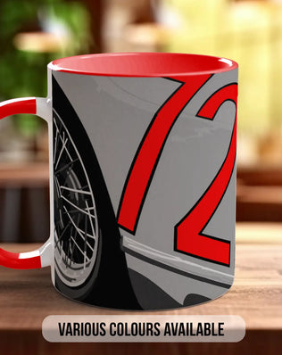 A red and gray mug with a graphic design featuring a wheel and the number 72 on it, placed on a wooden surface.
