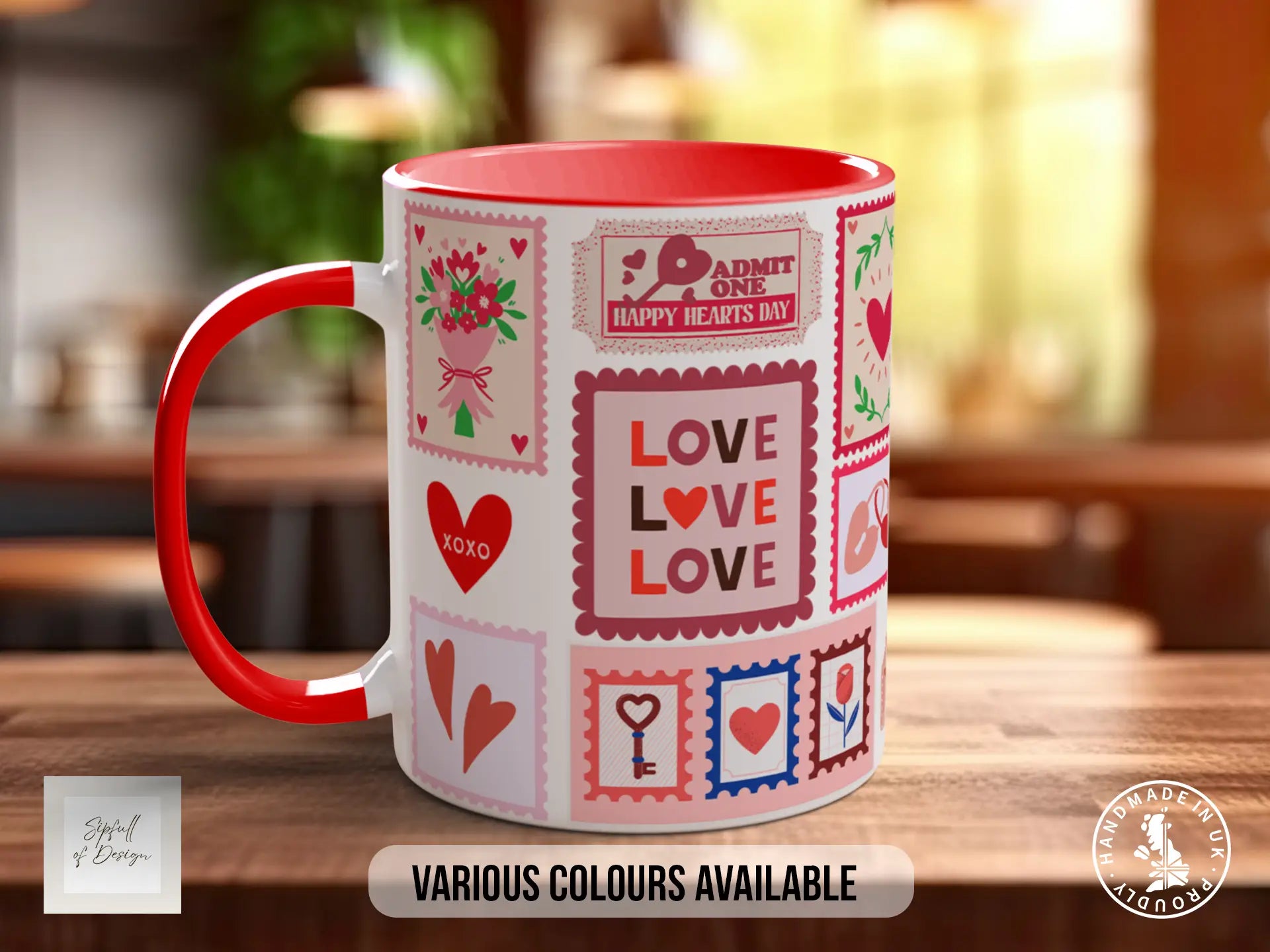A red and white mug with various heart-themed designs and text, including "Love", "Admit One Happy Hearts Day", and "Love". The mug is displayed on a wooden surface, and there is text indicating that "Various Colours Available" and "Handmade in UK".