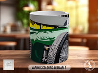 A mug with a colorful graphic design depicting a car and a city skyline.