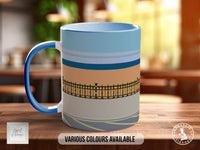 A blue and white mug with a striped pattern on it, placed on a wooden surface.