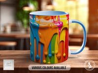 A colorful mug with a vibrant paint drips pattern, sitting on a wooden surface.