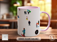 A white mug with a pink handle, featuring various colorful illustrations of people and objects.