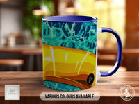 A colorful mug with a vibrant design, placed on a wooden surface.