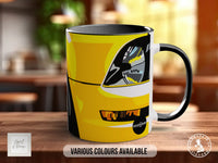 A yellow and black mug with a graphic design of a car's headlight and taillight.