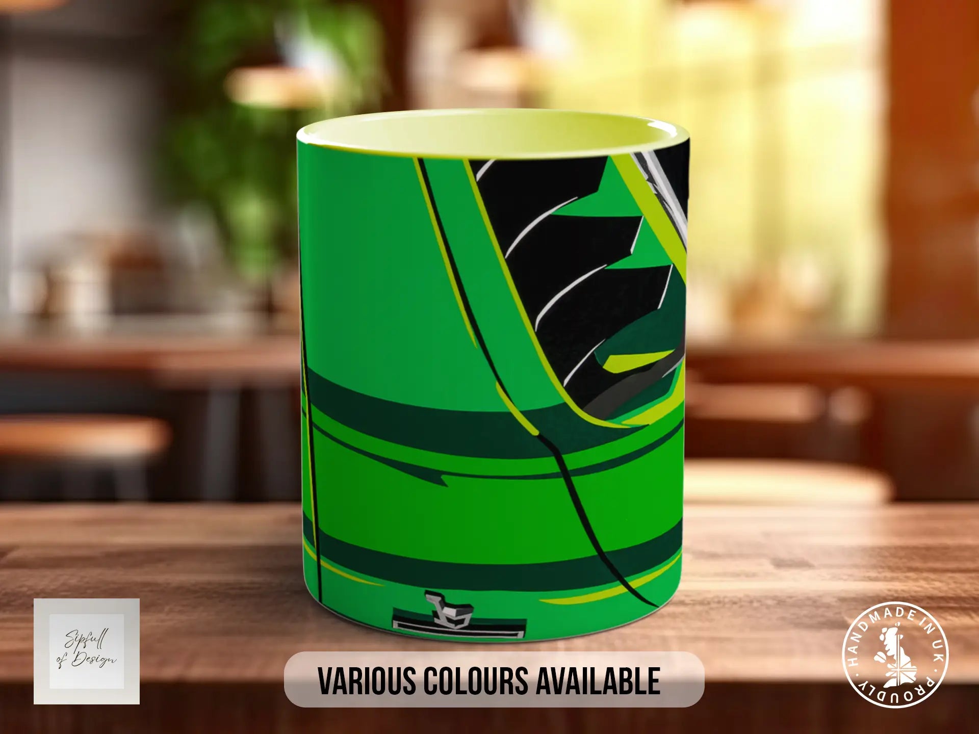 A green and black abstract design on a ceramic mug, with the text "Various colors available" and "Handmade in UK" displayed.