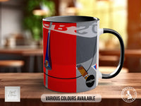 A mug with a colorful design featuring a red and black background, a blue and white striped pattern, and various icons and logos.