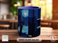 A blue mug with a graphic design on it, sitting on a wooden surface.