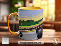 A colorful mug with an illustration of a car on the side, placed on a wooden surface.