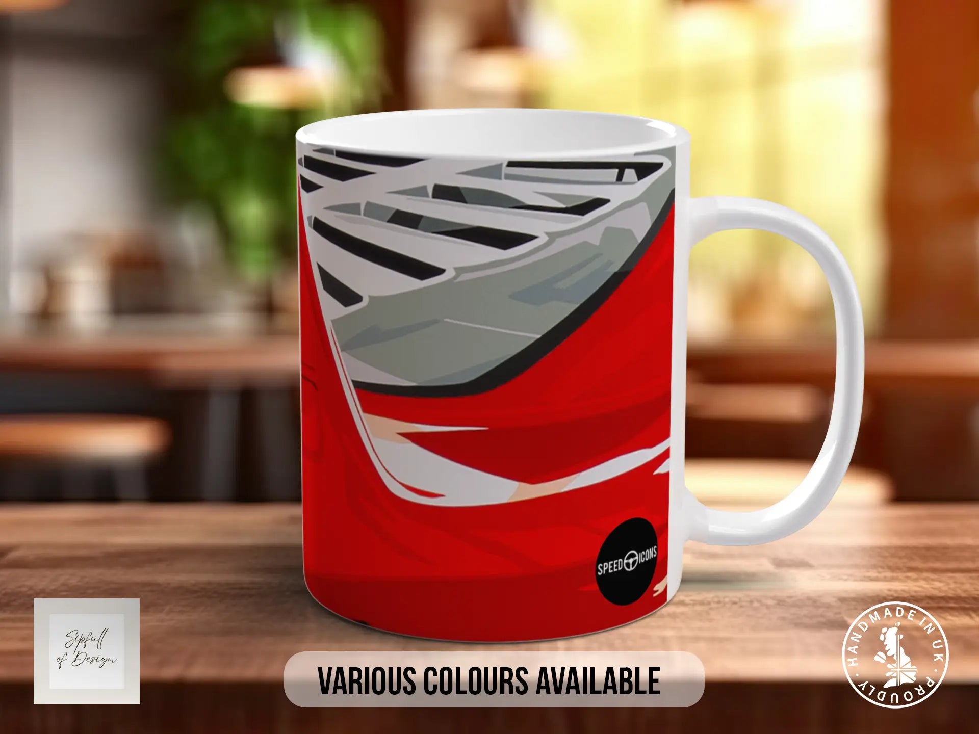 A red and white mug with a graphic design on it, placed on a wooden surface.
