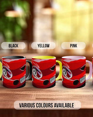 a row of five red mugs with different color options, including green, black, yellow, pink, and white, arranged on a wooden surface.