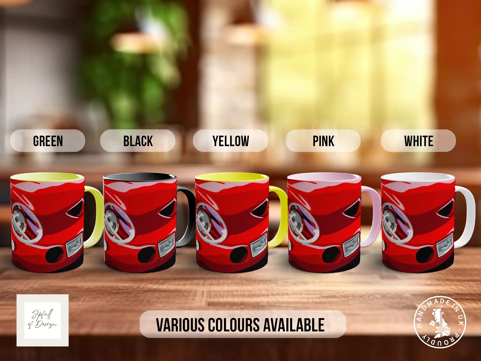 a row of five red mugs with different color options, including green, black, yellow, pink, and white, arranged on a wooden surface.