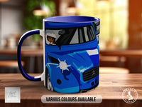 A blue mug with a graphic of a car on it, sitting on a table.