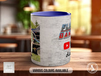 A mug with a printed design featuring a car and the text "FLY BANDS" and "YouTube" on it, sitting on a wooden surface.