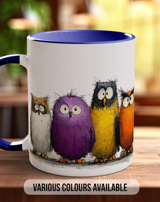 A white mug with a blue rim, featuring a colorful illustration of four cartoon owls in various colors.