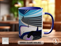A mug with a colorful abstract design on it, sitting on a wooden surface.