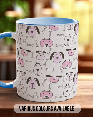 A white mug with a blue handle, featuring a repeating pattern of pink and black dog faces and bones on its surface.