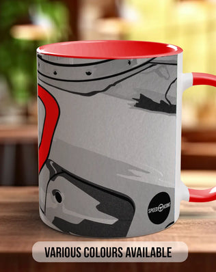 A red and gray mug with a graphic design on it, placed on a wooden surface.