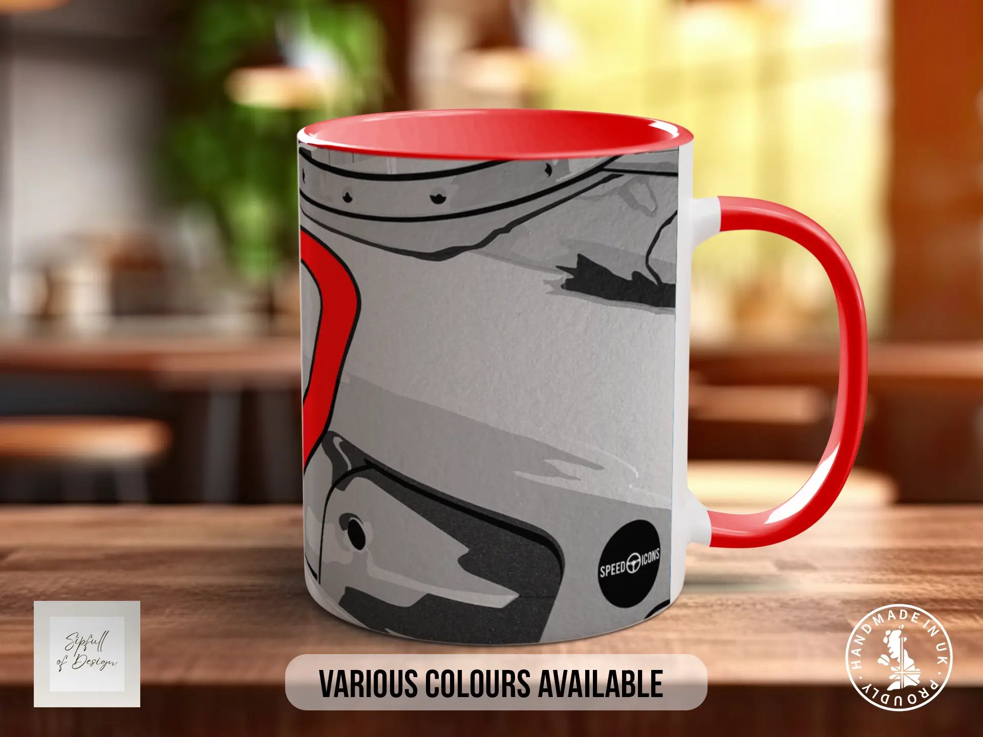 A red and gray mug with a graphic design on it, placed on a wooden surface.