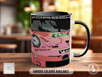 A black and pink mug with a racing car design, featuring various sponsor logos and text.