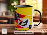A yellow and black mug with a graphic design featuring a motorcycle and Shell branding.