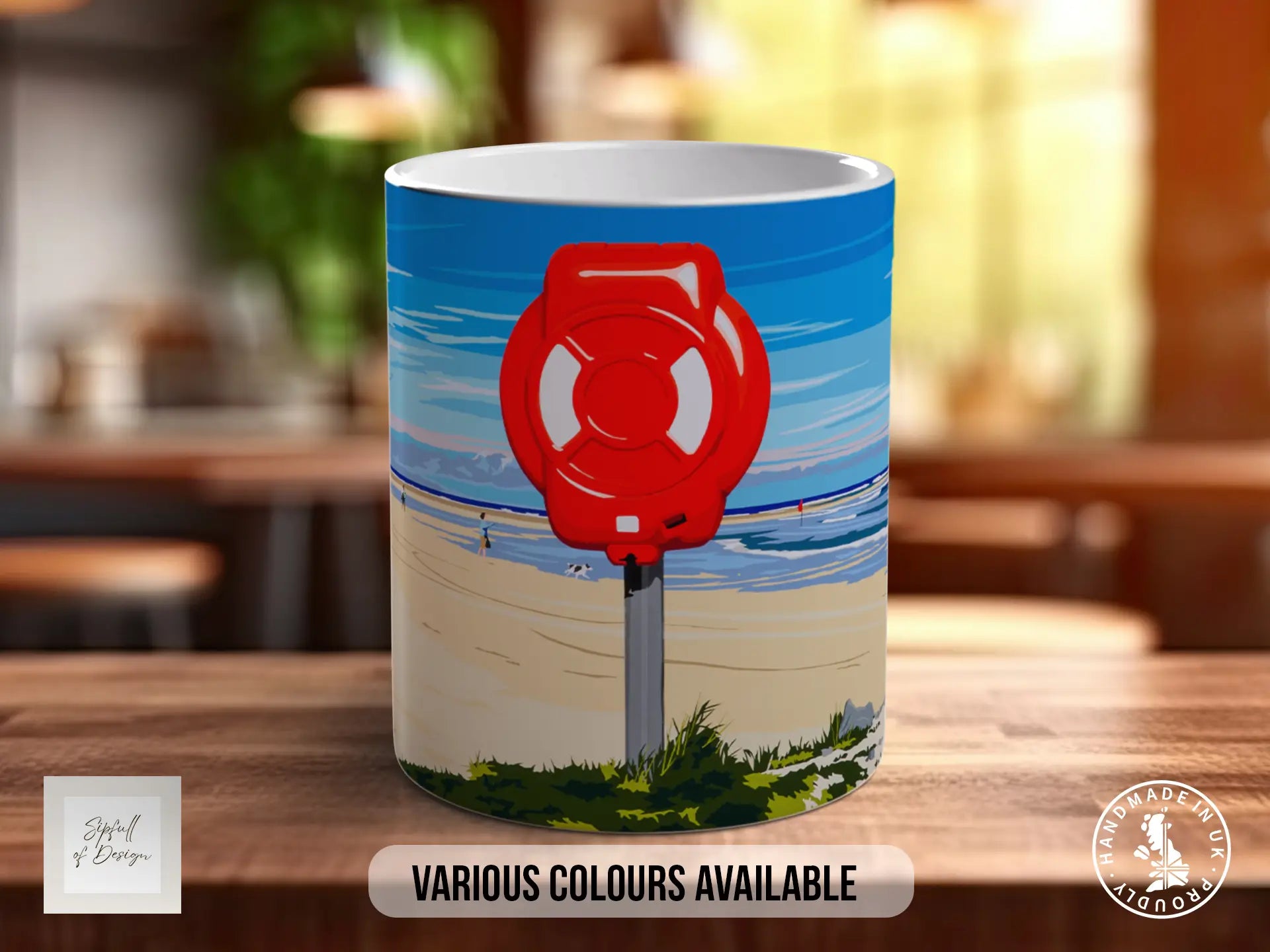A mug with a beach scene and a red life preserver on it, along with the text "Various colors available" and "Made in UK".