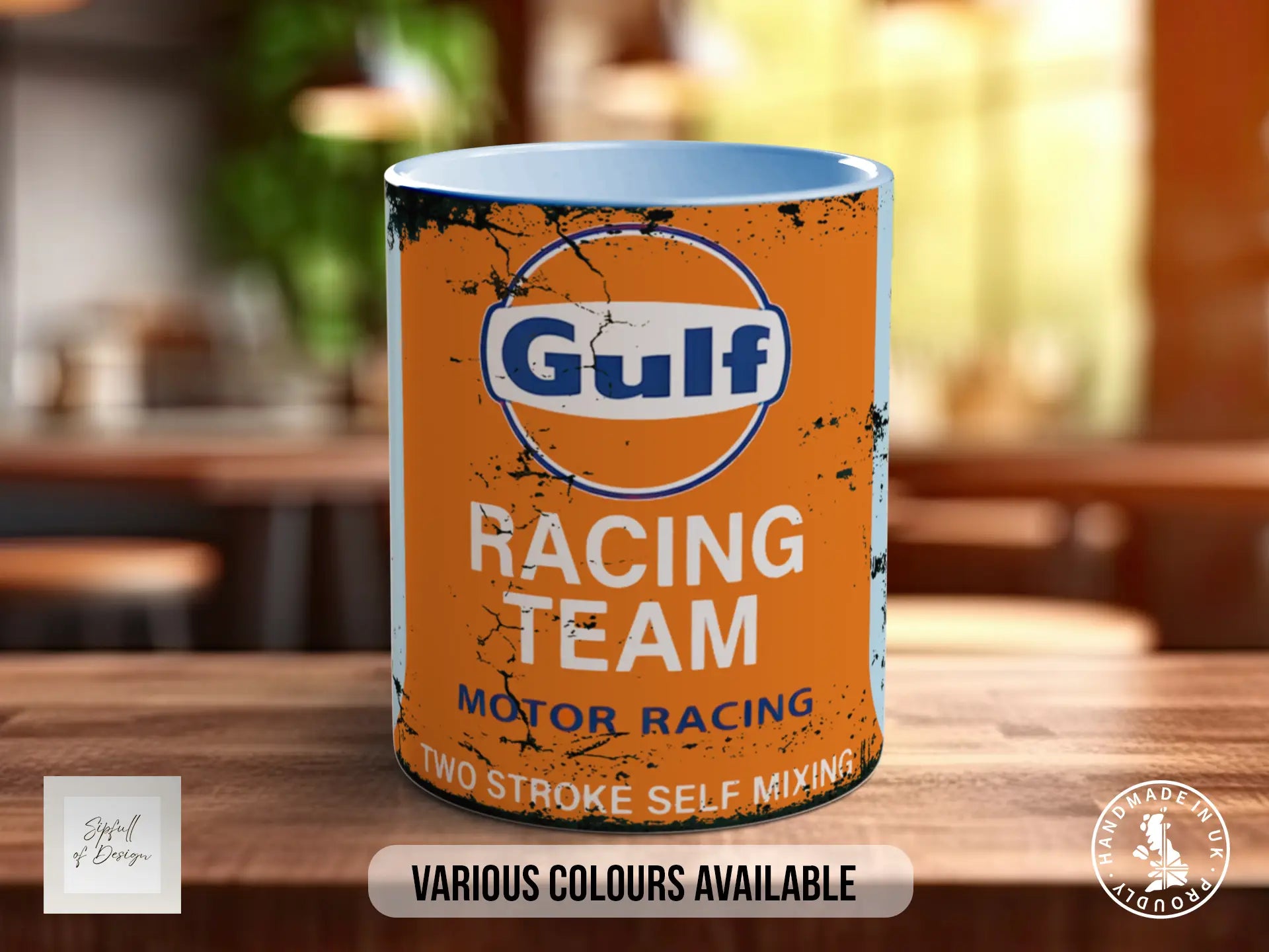 a mug with a racing team logo, placed on a wooden surface.