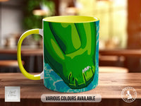 A colorful mug with a green and yellow design, placed on a wooden surface.