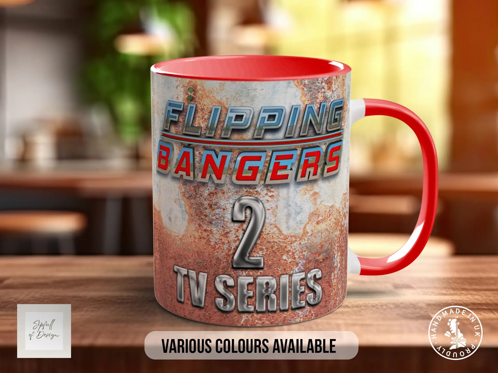 A red and silver mug with the text "FLIPPING BANGERS 2 TV SERIES" printed on it, placed on a wooden surface.