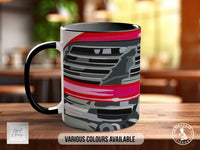 A black and white mug with a graphic design featuring a car or vehicle on the front.